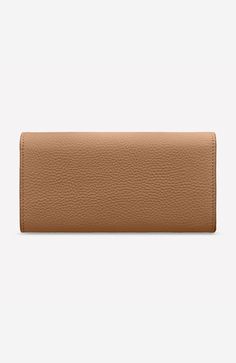 An ultra-chic everyday companion that illuminates through to evening, the Long Flap Wallet is crafted from our signature buttery soft full-grain leather. Featuring a full-length external flap, hand-massaged to precisely snap and secure valuables, the wallet also stows cards in eight slots and cash in two note compartments and a zipped coin pouch. A monochromatic exterior radiates elegance while a contrast colour interior provides a pop of play and enhanced on-the-go retrieval as it shines a spot Classic Beige Leather Wallet, Beige Leather Wallet For Daily Use, Beige Leather Wallet, Beige Leather Everyday Wallets, Elegant Leather-lined Clutch Wallet, Elegant Brown Wallet With Magnetic Closure, Everyday Beige Leather Wallet, Elegant Brown Wallets With Magnetic Closure, Elegant Clutch Wallet With Leather Lining