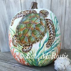 a painted pumpkin with a turtle on it