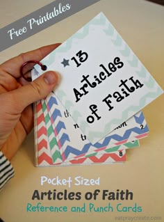 a person holding up some cards with the words pocket sized articles of faith on them