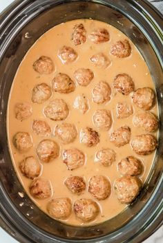 a crock pot filled with meatballs and gravy