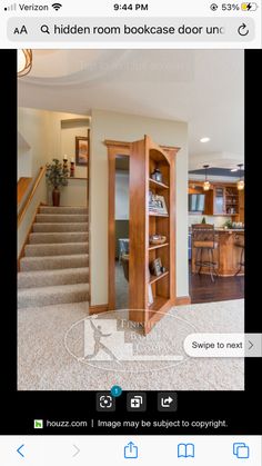 an open door leading to a living room with stairs and kitchen in the back ground