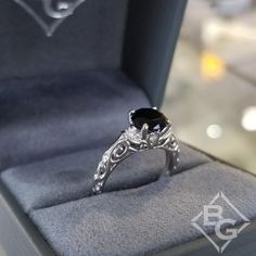 Artcarved Peyton Black Diamond Engagement Ring Featuring Scrollwork Design Classic Black Sapphire Oval Ring, Classic Black Rings For Anniversary, Elegant Black Oval Ring, Classic Black Oval Sapphire Ring, Exquisite Black Formal Jewelry, Classic Black Diamond Ring As A Gift, Oval Black Rings With Black Diamonds, Black Oval Rings With Black Diamonds, Classic Formal Black Diamond Ring