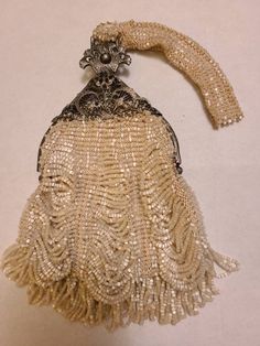 This purse is in excellent condition. I'm not positive if it is Victorian or from the 20's. It was either never used or has been professional cleaned. All the beads seem to be there and intact. Strap measures about 6" the bag part about 6" and the width about 5" Victorian Purses, Filigree Frame, Swag Bag, Vintage Purses, Choker Style, Formal Casual, Beaded Purses, Feminine Design, Glass Bead Necklace