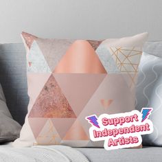 a throw pillow with the words support independent artists on it in front of a couch