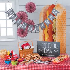 a hot dog bar with buns and other foods