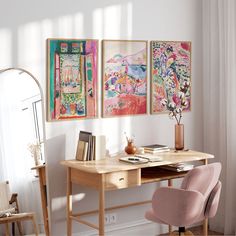 a desk with two paintings on the wall