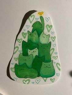 a drawing of green cats with hearts on them