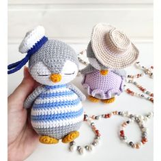 two small crocheted stuffed animals sitting next to each other