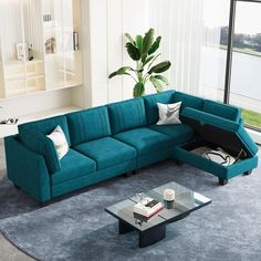 a living room with a blue couch and coffee table in front of a large window