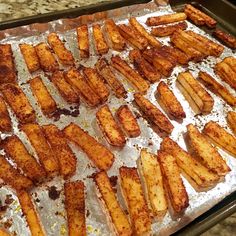 some fried food is sitting on a baking sheet and ready to be cooked in the oven