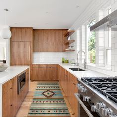 a kitchen with wooden cabinets and white counter tops