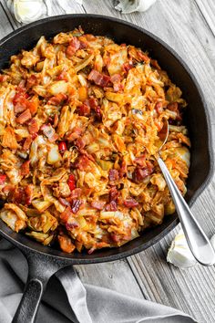 an iron skillet filled with cabbage and bacon