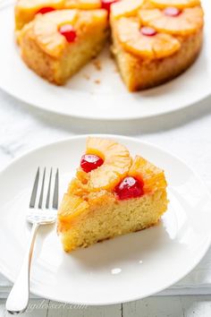 a piece of pineapple upside down cake on a white plate with a fork next to it