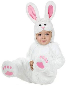 a baby dressed in a bunny costume with paws on it's chest and feet