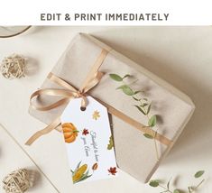 a gift wrapped in brown paper and tied up with a ribbon, next to some autumn leaves