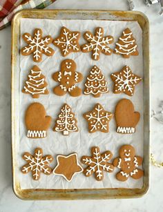 gingerbread cookies decorated with icing on a baking sheet