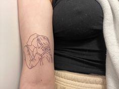 a woman's arm with a small tattoo on the left side of her arm