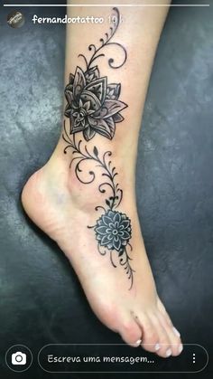 a woman's foot with a flower tattoo on the top and bottom of it