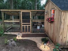 a small chicken coop in the middle of a yard