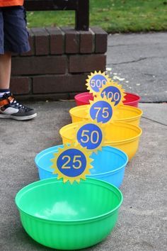 four buckets with numbers on them sitting in front of a brick wall