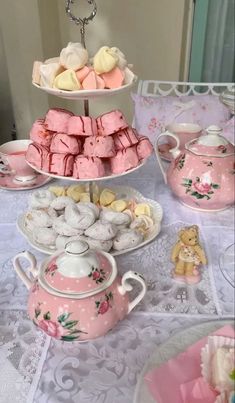 three tiered trays filled with different types of pastries and cookies on top of a table