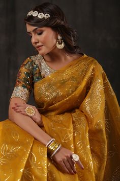 Alluring mustard organza saree is a perfect choice for parties! The saree comes with a designer Kalamkari saree blouse. Disclaimer: The actual product may vary slightly from the image. These are custom orders, hence expect slight variation in color, placement of the motif or buta. ESTIMATED DELIVERYBecause this is a custom order, it would take about 4 weeks from the date of purchase. RETURN POLICYThis product is a custom order and cannot be returned or exchanged. Gold Organza Pre-draped Saree For Navratri, Gold Dola Silk Blouse With Dupatta, Yellow Cotton Silk Blouse Piece With Pallu, Yellow Tissue Silk Blouse With Zari Work, Yellow Cotton Silk Pre-draped Saree With Unstitched Blouse, Navratri Gold Chanderi Pre-draped Saree, Gold Tussar Silk Choli For Navratri, Yellow Chanderi Bollywood Blouse, Yellow Bollywood Chanderi Blouse