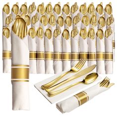 a set of gold and white place setting with napkins, silverware and forks