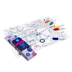 a drawing mat with markers and crayons on it for kids to color in