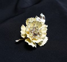 "This lovely pale yellow enamel vintage flower brooch by Coro is in overall nice condition. The enamel is slightly chipped in a few areas, wear that seems appropriate for its age. There is some movement/play between the pin/flower stem and the flower part of the pin. It seems purposeful but I don't know that for sure. Overall it's a very pretty pin. All stones accounted for. Stamped on back. Width - 2\" at widest point Length - 3 1/4\" Find more vintage brooches and pins from my shop here! ~ https://www.etsy.com/shop/AnnWoodallStudios?ref=seller-platform-mcnav&section_id=22220795 If you are interested in a vintage item, please examine the photographs carefully and feel free to contact me with any questions you might have. I'll do my best to answer them, though I am not a professional jewel Elegant Yellow Flower Brooches, Vintage Yellow Flower Brooch, Flower-shaped Enamel Brooches For Wedding, Flower Shaped Enamel Brooches For Wedding, Wedding Flower-shaped Enamel Brooches, Parts Of A Flower, Flower Stem, Pretty Pins, Professional Jewelry