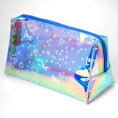 Carry your makeup and other essentials in style! Holographic, graffiti makeup bag provides ample space for travel and everyday. Closure: Zipper Dimensions: 8'' W x 5'' H Material: PU - Claire's Medium Holographic Graffiti Makeup Case - Blue Trendy Blue Cosmetic Bag For School, Trendy Blue Cosmetic Bag For Travel, Trendy Blue Travel Cosmetic Bag, Trendy Blue Pouch Pencil Case, Trendy Blue Rectangular Pouch, Trendy Rectangular Cosmetic Bag, Blue Rectangular Pencil Case With Zipper, Blue Rectangular Pencil Case With Zipper Closure, Trendy Blue Rectangular Cosmetic Bag