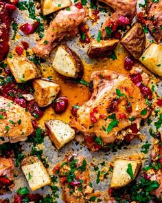 chicken, potatoes and cranberry sauce on a baking sheet