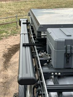 the back end of a truck with luggage strapped to it