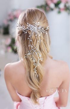 the back of a woman's head wearing a bridal hair comb with crystal beads