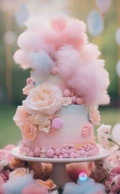 a pink and blue cake with flowers on top