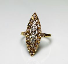 an antique diamond ring on a white surface