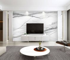 a modern living room with white furniture and marble wallpaper, along with a flat screen tv mounted on the wall