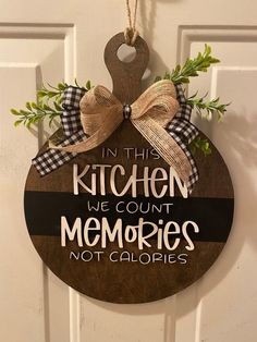 a wooden sign that says in this kitchen, we count memories not caloriess