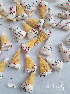 there are many cones that have been decorated with icing and sprinkles