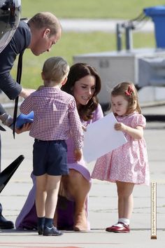 the duke and princess of cambridge are greeted by young children as they board an airplane