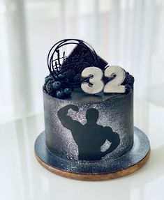 a birthday cake with the number twenty two and a silhouette of a man on it