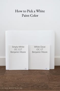 two white books sitting on top of a wooden floor next to a wall with the words how to pick a white paint color