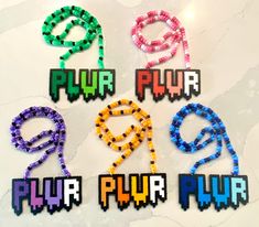 six different colored beads with the word pur pyr written on them in small letters