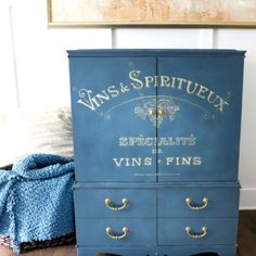 an old dresser painted blue and gold with the words vans & sprittux on it