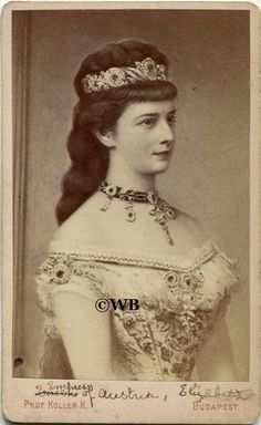 an old photo of a woman wearing a tiara