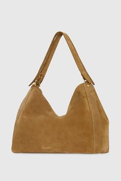 The newest member of the M. A. B. family features the same supple suede and minimal design, but in a larger size that will fit your laptop and all other daily essentials. Style# HF24TSUT4P 100% Suede Leather Antique Brass Hardware 15" W X 12" H X 6. 5" D Handle drop: 6. 5" One interior zip pocket One exterior zip pocket Snap closure Imported The photos featuring a model are for size reference only. Actual color and material may vary from what is depicted. | Rebecca Minkoff M.A.B. Carryall Bag In Everyday Suede Shoulder Bag With Gold-tone Hardware, Classic Everyday Suede Shoulder Bag, Leather Outerwear, Antique Brass Hardware, Chevron Quilt, Large Shoulder Bags, Carry All Bag, Leather Dresses, Small Tote