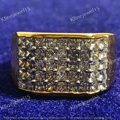 an 18k yellow gold ring set with square cut diamonds and pave settings