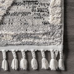 a white rug with tassels on top of it