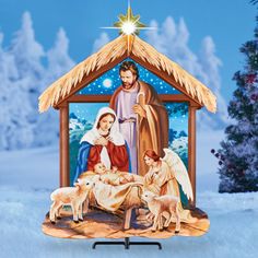 a nativity scene with the birth of jesus and three sheeps in front of a christmas tree