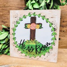 a wooden sign with a cross on it that says, hey roon and flowers