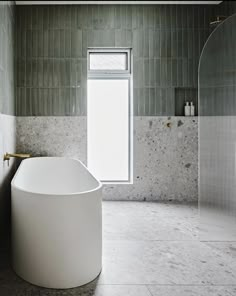 a large white bath tub sitting next to a window